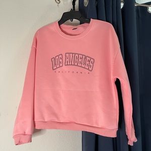 SHEIN sweatshirt. Large. Pink w/black lettering spelling Los Angelos California.